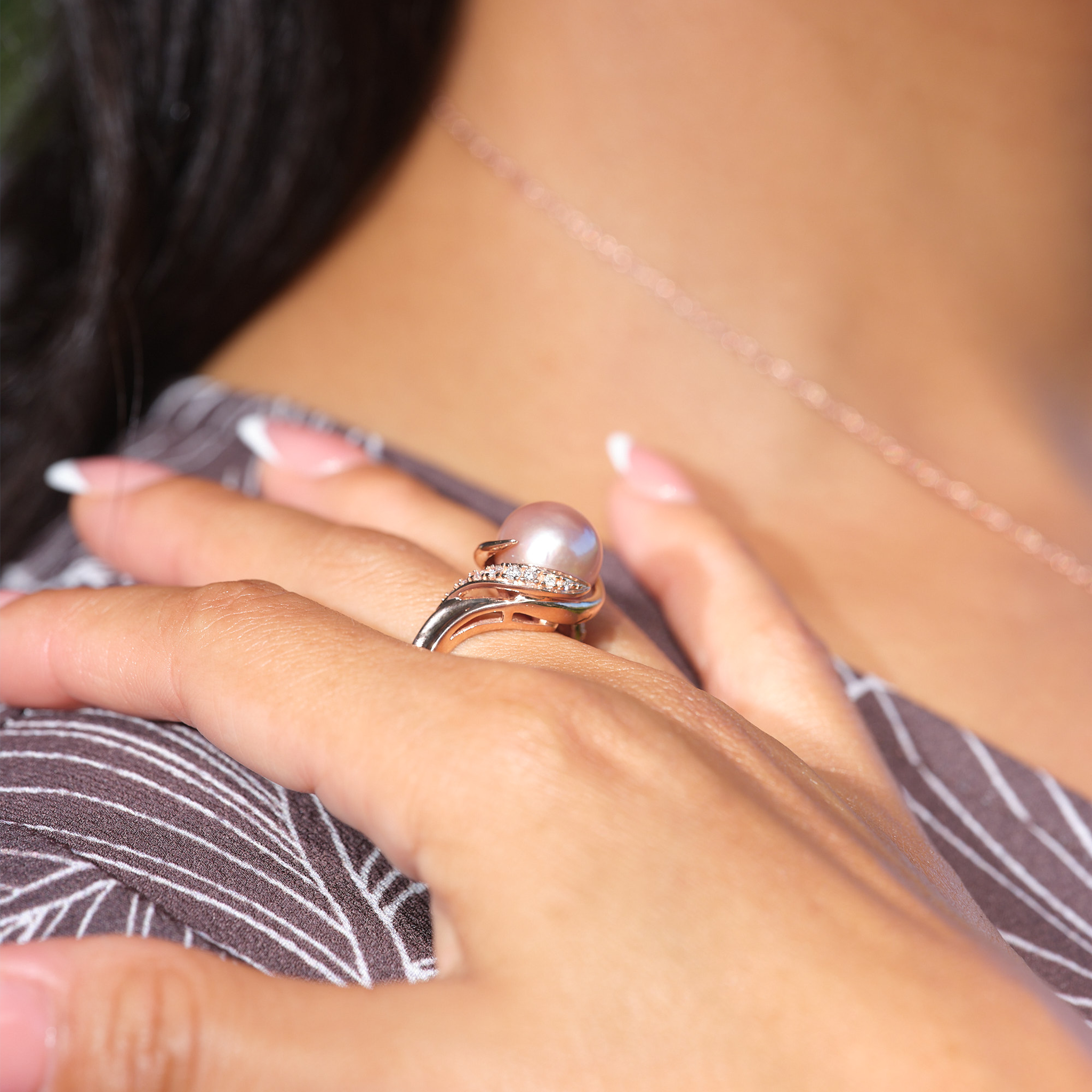 A woman's hand wearing a Lilac Freshwater Pearl Ring with Diamonds in Rose Gold (12-13mm)-Maui Divers Jewelry