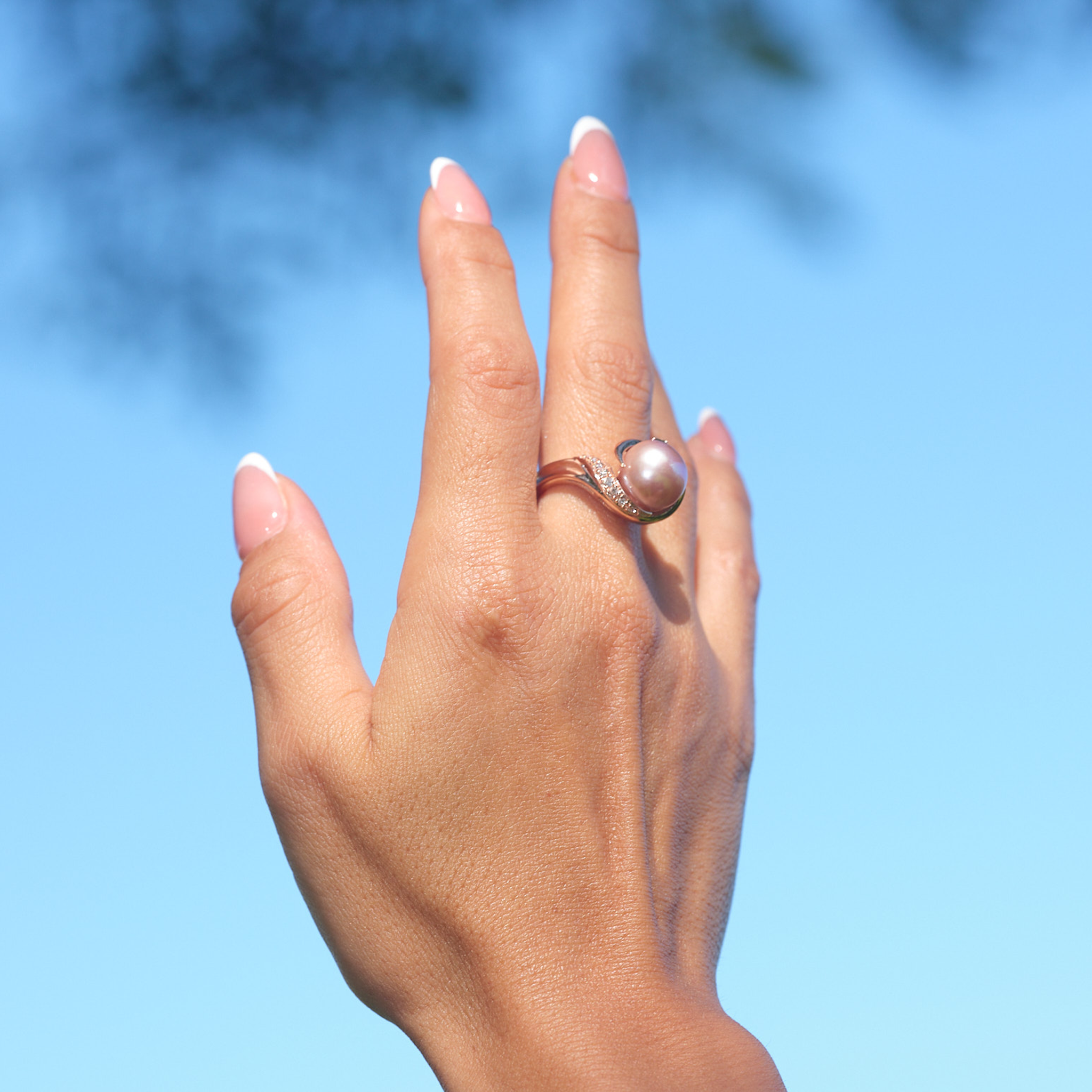 A woman's hand wearing a Lilac Freshwater Pearl Ring with Diamonds in Rose Gold (12-13mm)-Maui Divers Jewelry