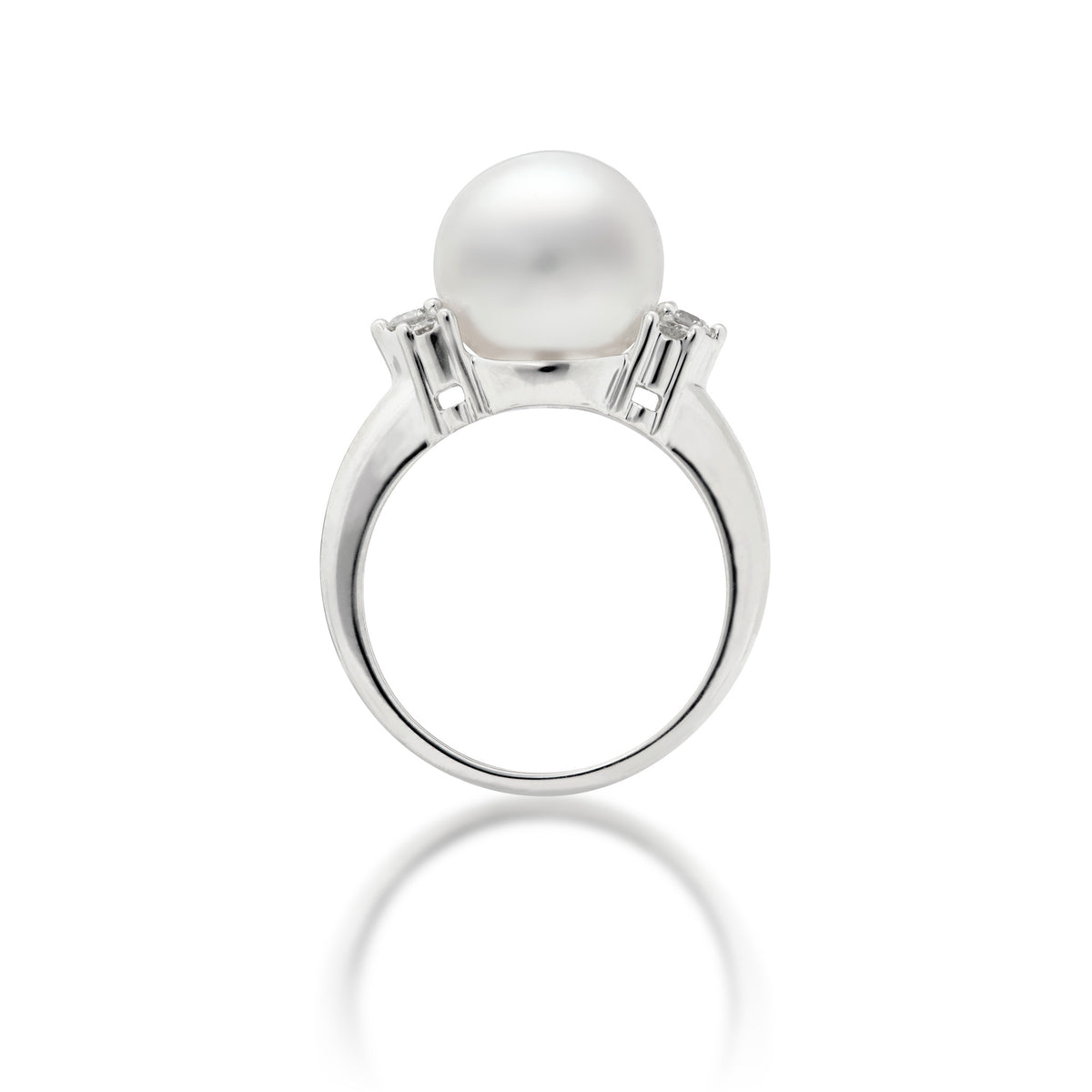 Side view of a 14k white gold ring featuring a large, lustrous South Sea White pearl as the center stone, accented by three diamonds on either side of the band, set against a clean white background with a soft reflection below.