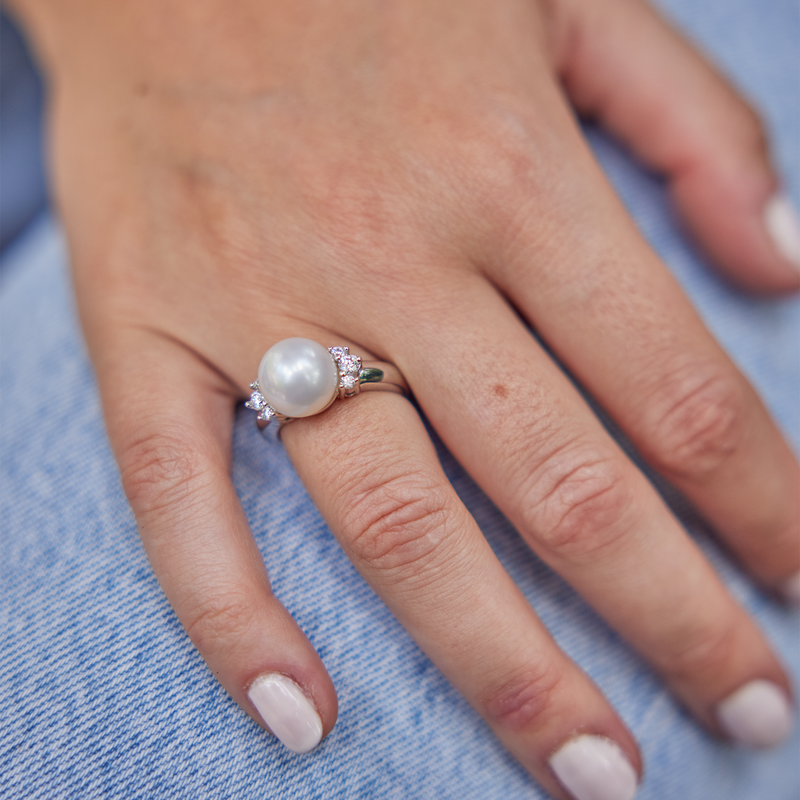 Hand on jeans wearing South Sea White Pearl Ring in White Gold with Diamonds - 10-11mm