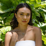Model wearing Tahitian Black Pearl Earrings in Gold - 9-10mm with nature background