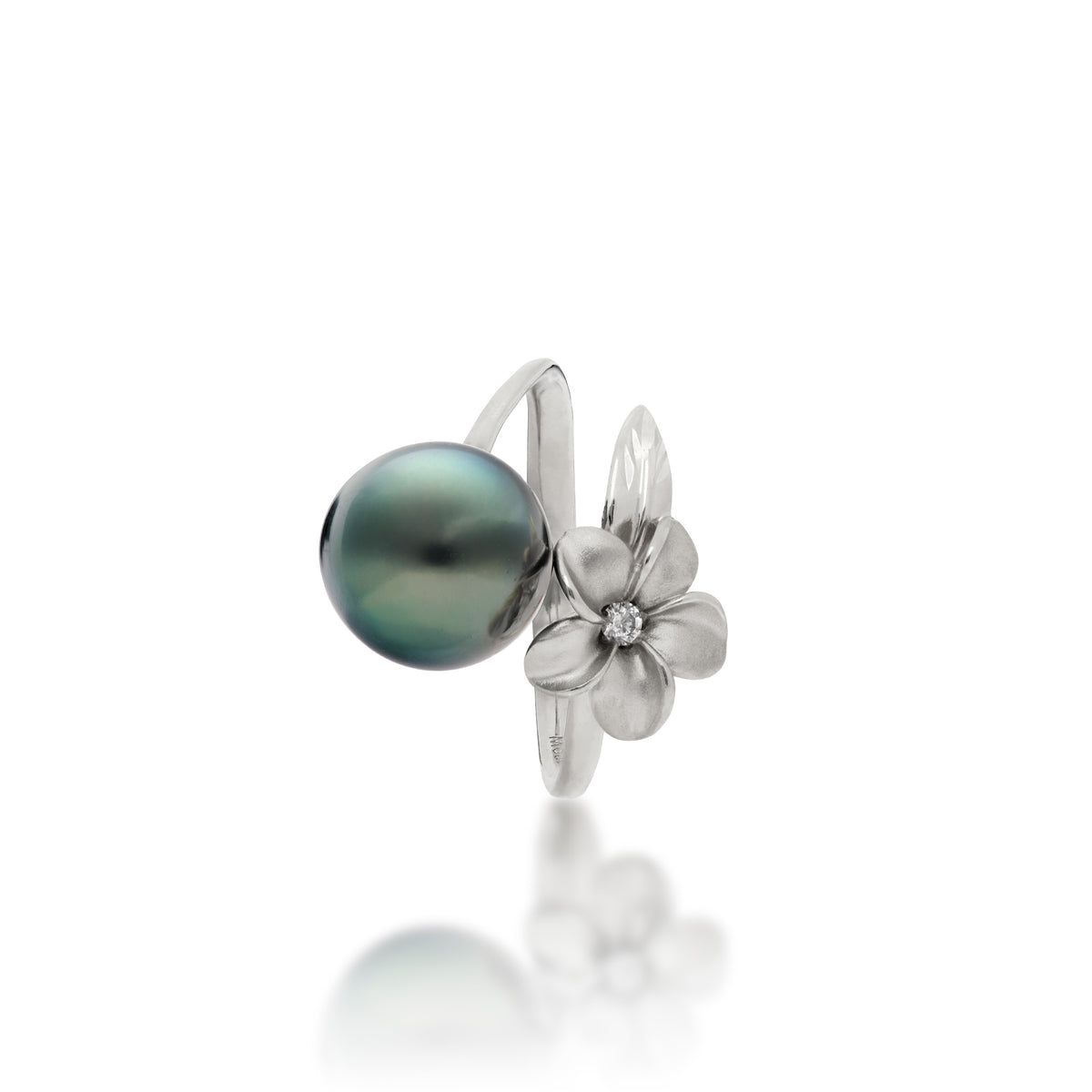 Top view of a 14k white gold bypass ring featuring a 10-11mm Tahitian black pearl and diamond-accented plumeria with a satin finish and diamond-cut leaf, set against a clean white background with a soft reflection.