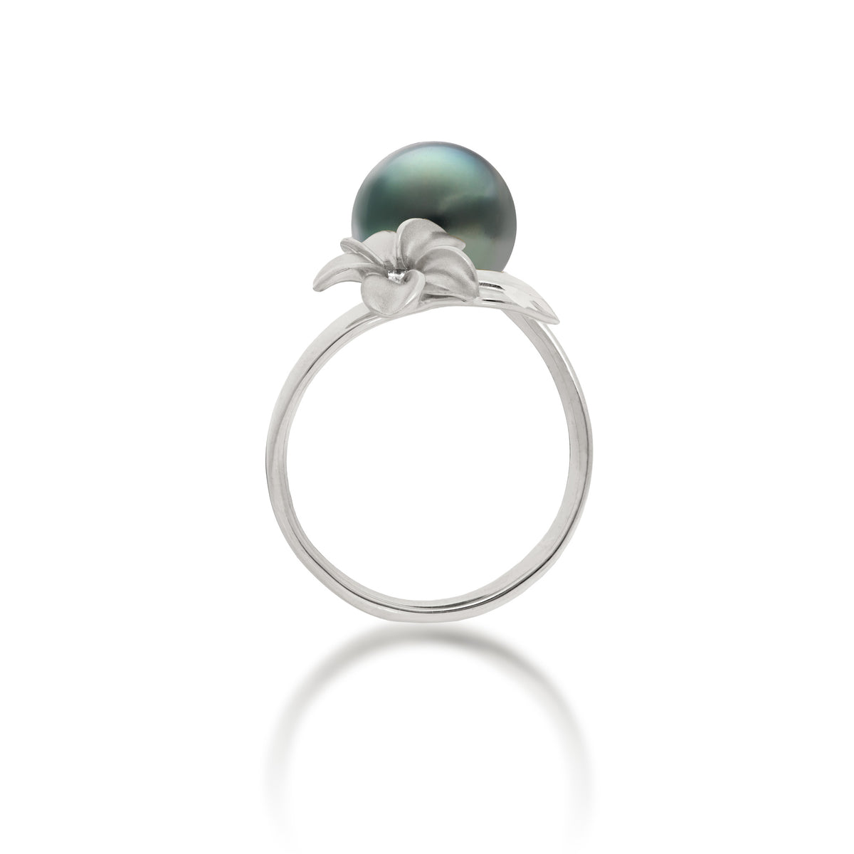 Side view of a 14k white gold bypass ring featuring a 10-11mm Tahitian black pearl and diamond-accented plumeria with a satin finish and diamond-cut leaf, set against a clean white background with a soft reflection.