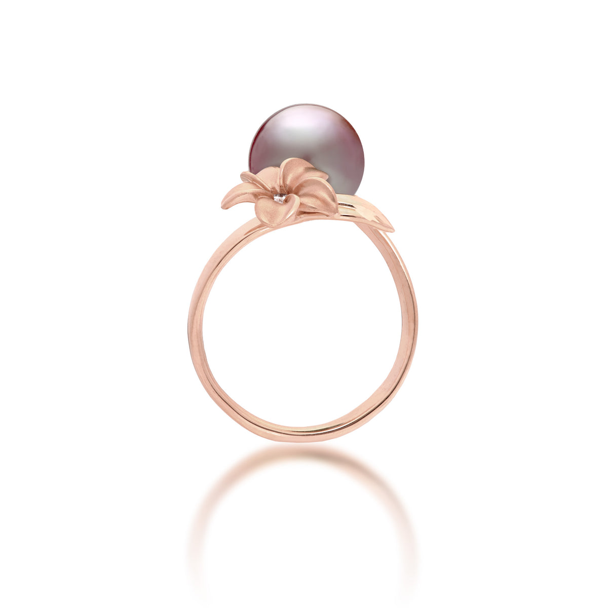 Side view of a 14k rose gold bypass ring featuring a 10-11mm lilac freshwater pearl and diamond-accented plumeria with a satin finish and diamond-cut leaf, set against a clean white background with a soft reflection.