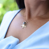 close up of woman wearing E Hoʻāla Tahitian Black Pearl Pendant in Gold with Diamonds - 27mm