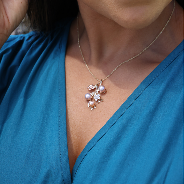 A womanʻs chest with a Pearls in Bloom Plumeria Lavender Freshwater Pearl Pendant in Tri Color with Diamonds - 36mm - Maui Divers Jewelry