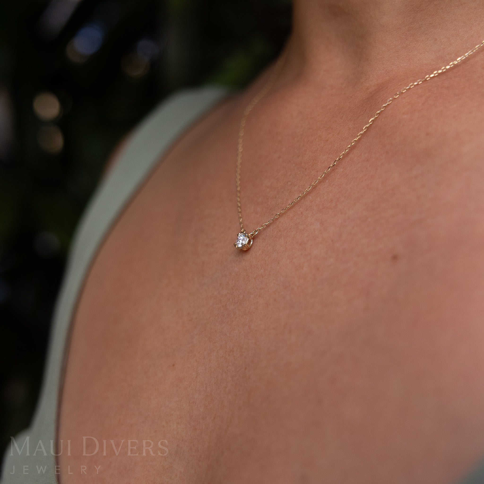 Close-up Side view of an Adjustable Hidden Hawaiʻi Maile Necklace in 14k Yellow Gold with a Lab Grown Diamond Worn Around A Neck