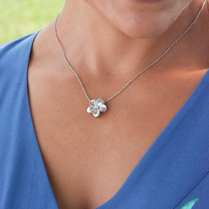 A woman's chest with a Plumeria Pendant in White Gold with Diamond - 16mm-Maui Divers Jewelry