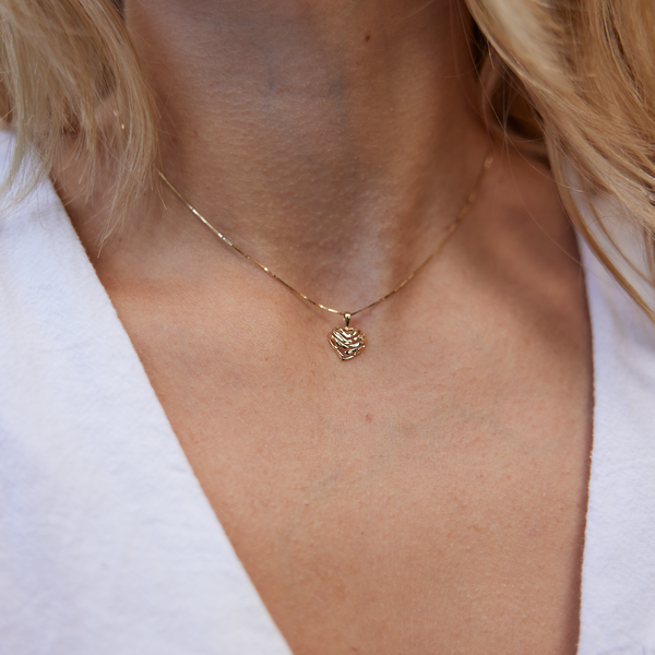 close up of woman's neckline wearing Aloha Heart Pendant in Gold - 9mm