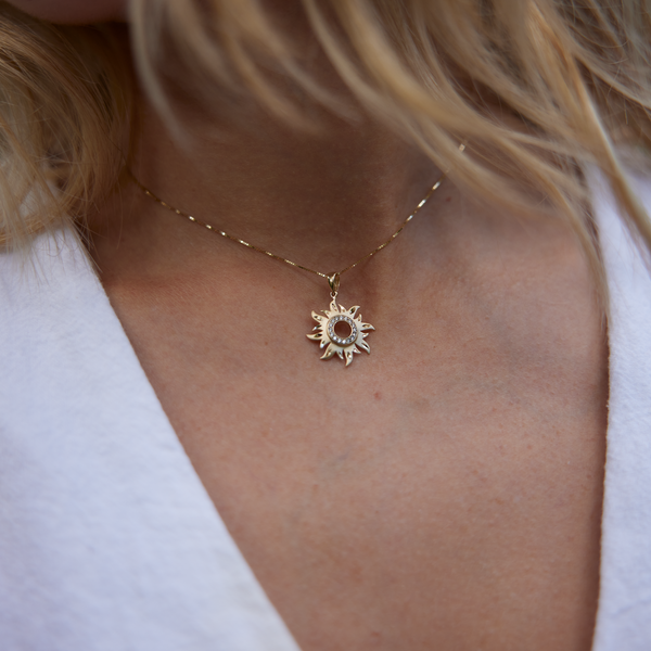 Close up of woman's neckline wearing Sun Pendant in Gold with Diamonds - 17mm