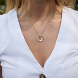 Close up of Nalu Pendant in Gold with Diamonds - 22mm on neckline