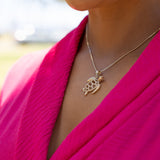 A woman's neck with a 1.3mm Ice Cube Chain in Gold with a Honu Pendant with Diamonds - Maui Divers Jewelry