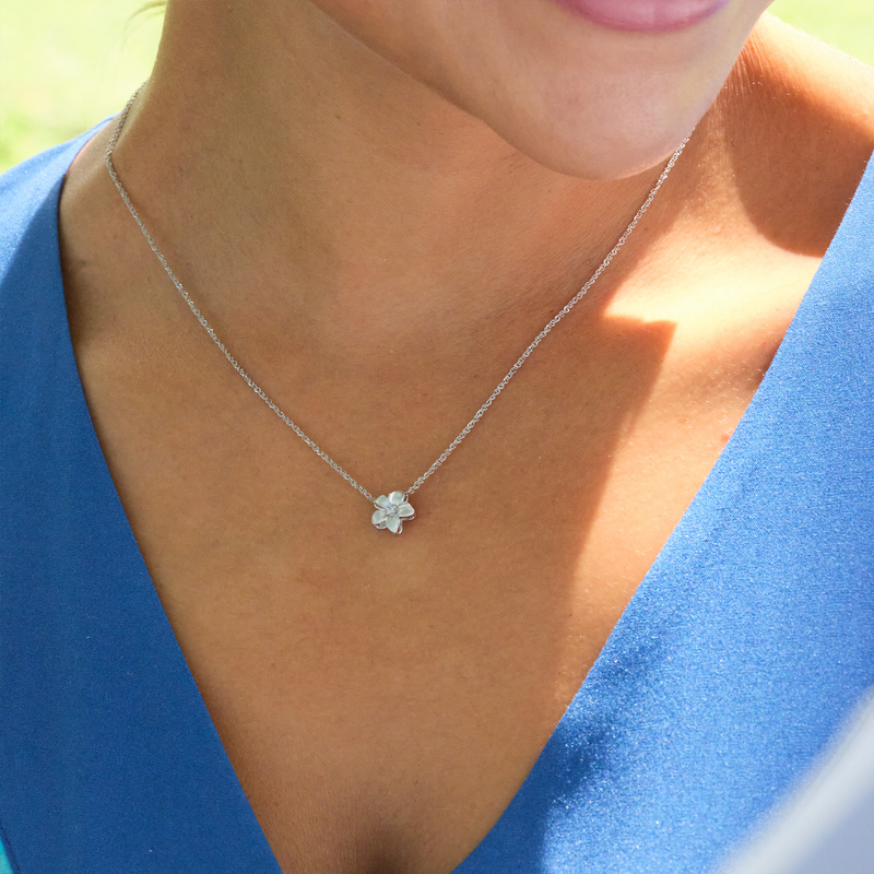 A woman wearing a Plumeria Pendant in White Gold with Diamond - 9mm-Maui Divers Jewelry
