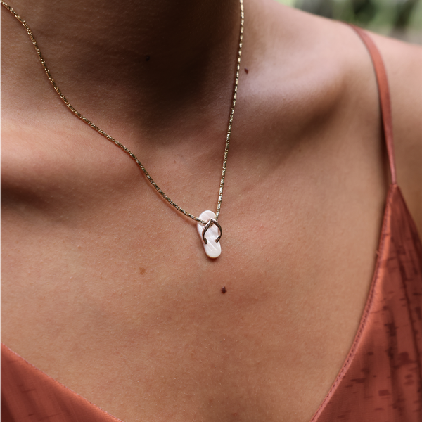 A woman wearing a Pink Mother of Pearl Slipper Pendant in Rose Gold - Maui Divers Jewelry