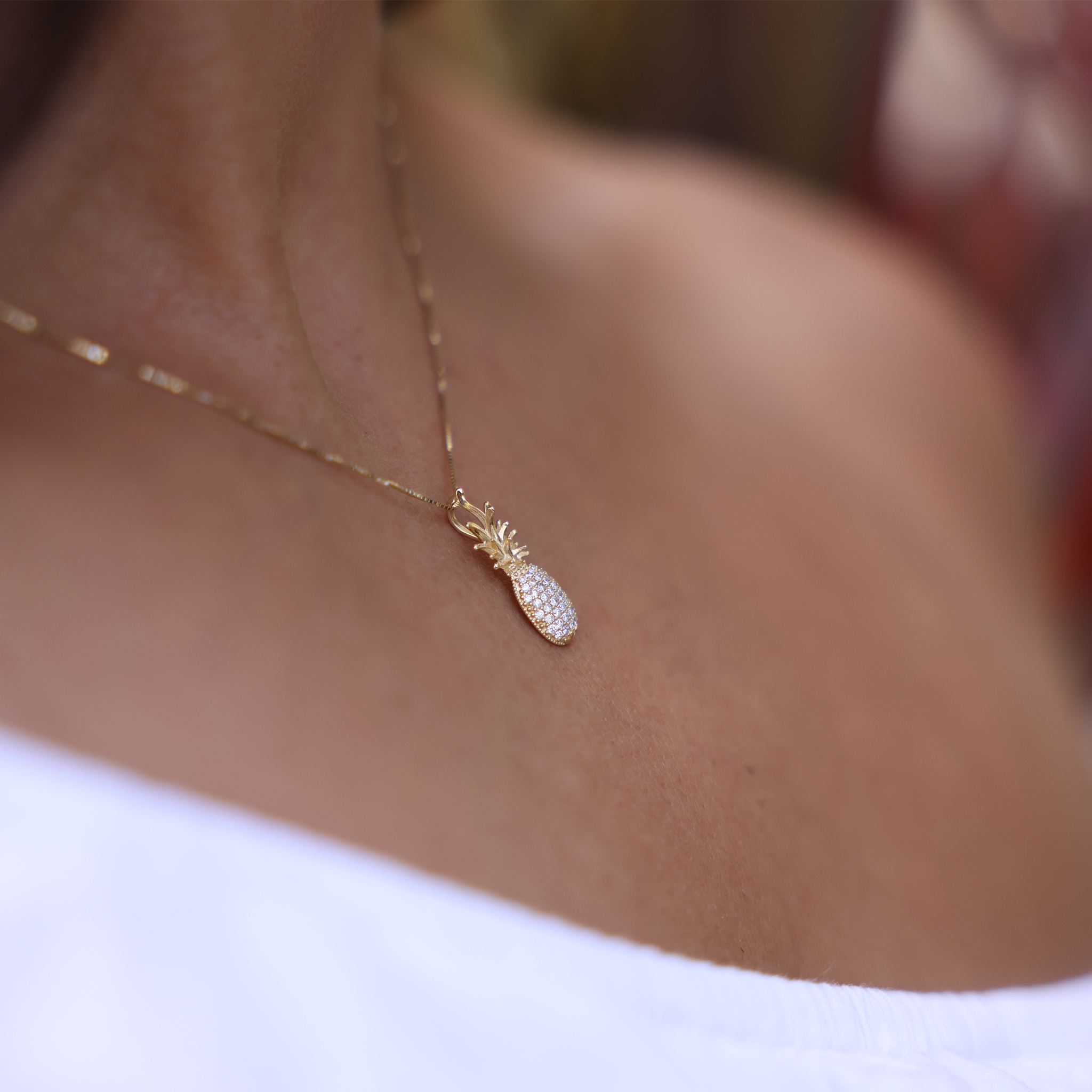 Woman Wearing Pineapple Pendant in Gold with Diamonds by Maui Divers Jewelry