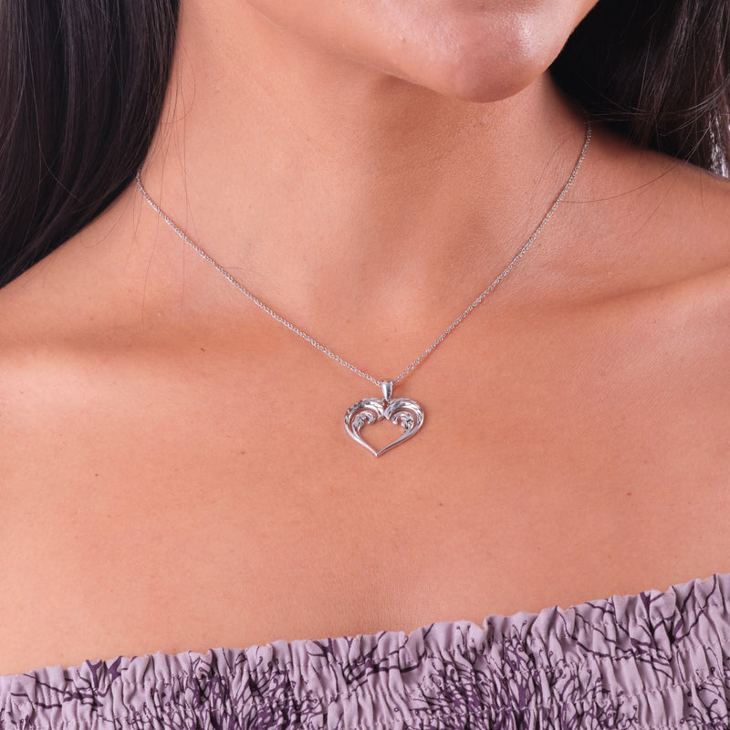 A woman's chest with a Nalu Heart Pendant in White Gold - 20mm -  Maui Divers Jewelry