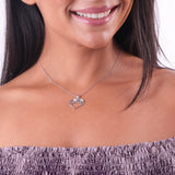 A woman's chest with a Nalu Heart Pendant in White Gold - 20mm - Maui Divers Jewelry