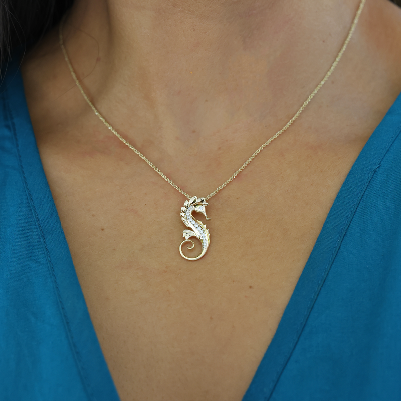 A woman's chest with Ocean Dance Seahorse Pendant in Gold with Diamonds - 24mm - Maui Divers Jewelry