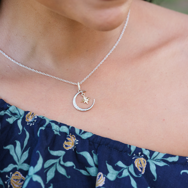 A woman wearing a Moon & Star Mermaid Pendant in Two Tone Gold with Diamonds - 19.5mm - Maui Divers Jewelry