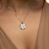Woman wearing Plumeria Pendant in Gold with Diamonds - 20mm with brown shirt