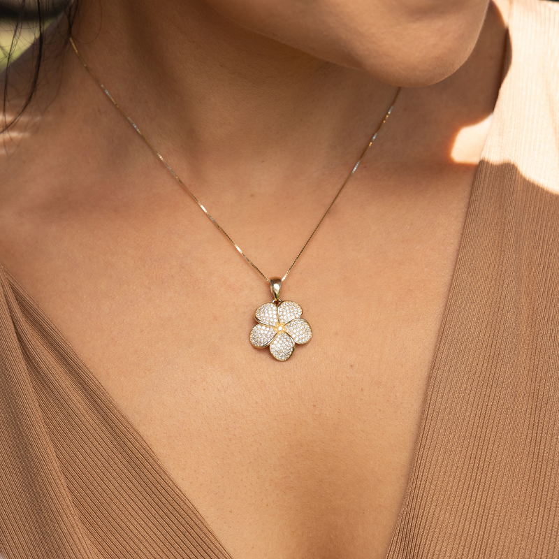 Woman wearing Plumeria Pendant in Gold with Diamonds - 20mm with brown shirt