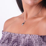 A woman's chest with a Paradise Black Coral Pendant in White Gold with Diamonds - 32mm - Maui Divers Jewelry