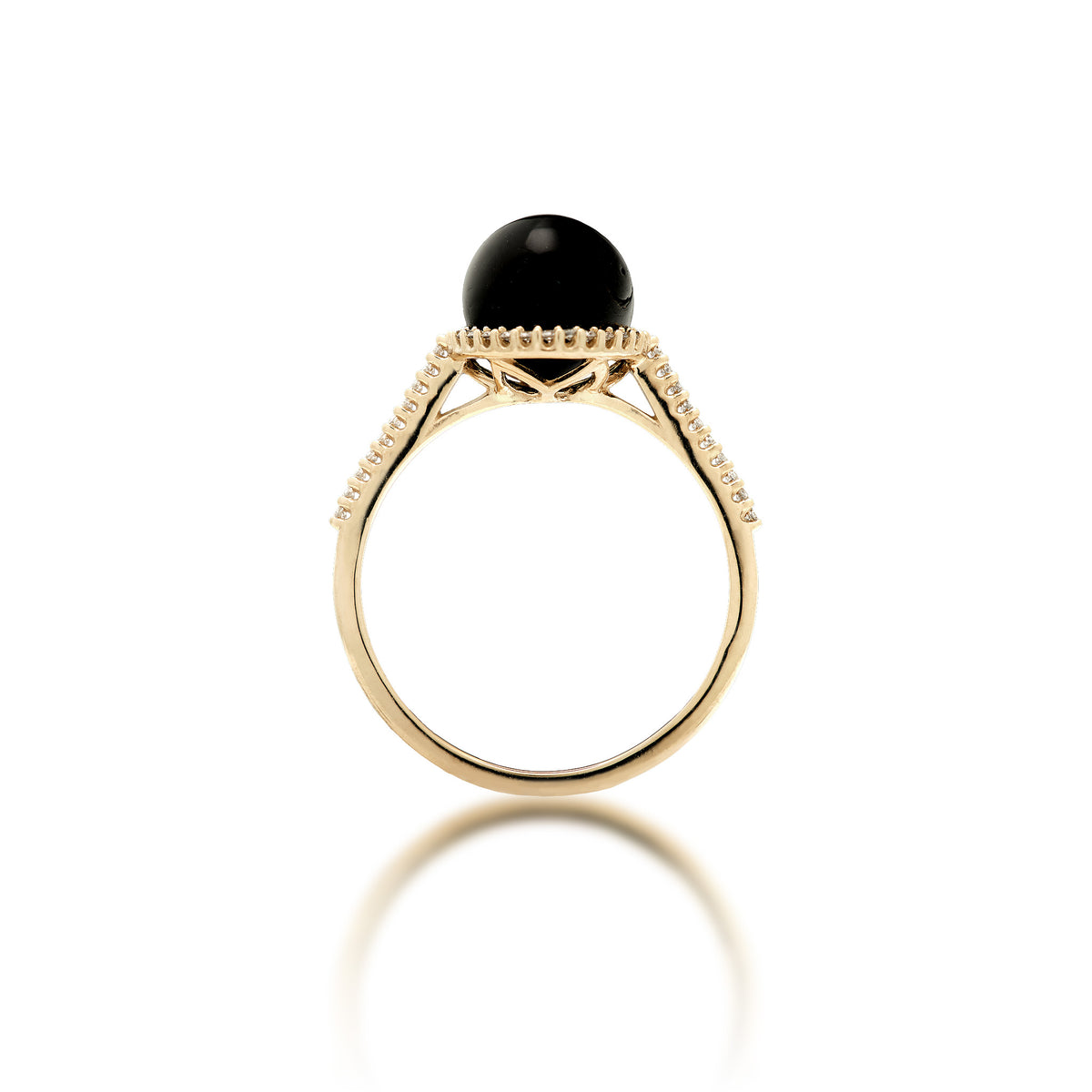 Side view of a 14k gold ring set with a high polished 7-7.9mm Round Hawaiian black coral surrounded with a diamond halo, diamond detail on top half of the band, placed on a reflective white surface.