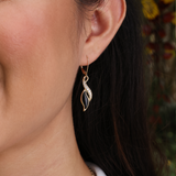 A woman's ear with Paradise Black Coral Earrings in Gold with Diamonds - Maui Divers Jewelry