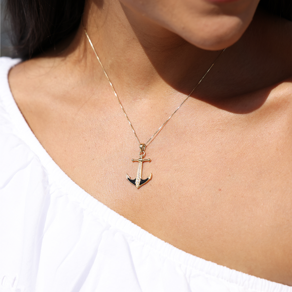 A womanʻs chest with a Sealife Anchor Black Coral Pendant in Gold with Diamonds - 28mm - Maui Divers Jewelry