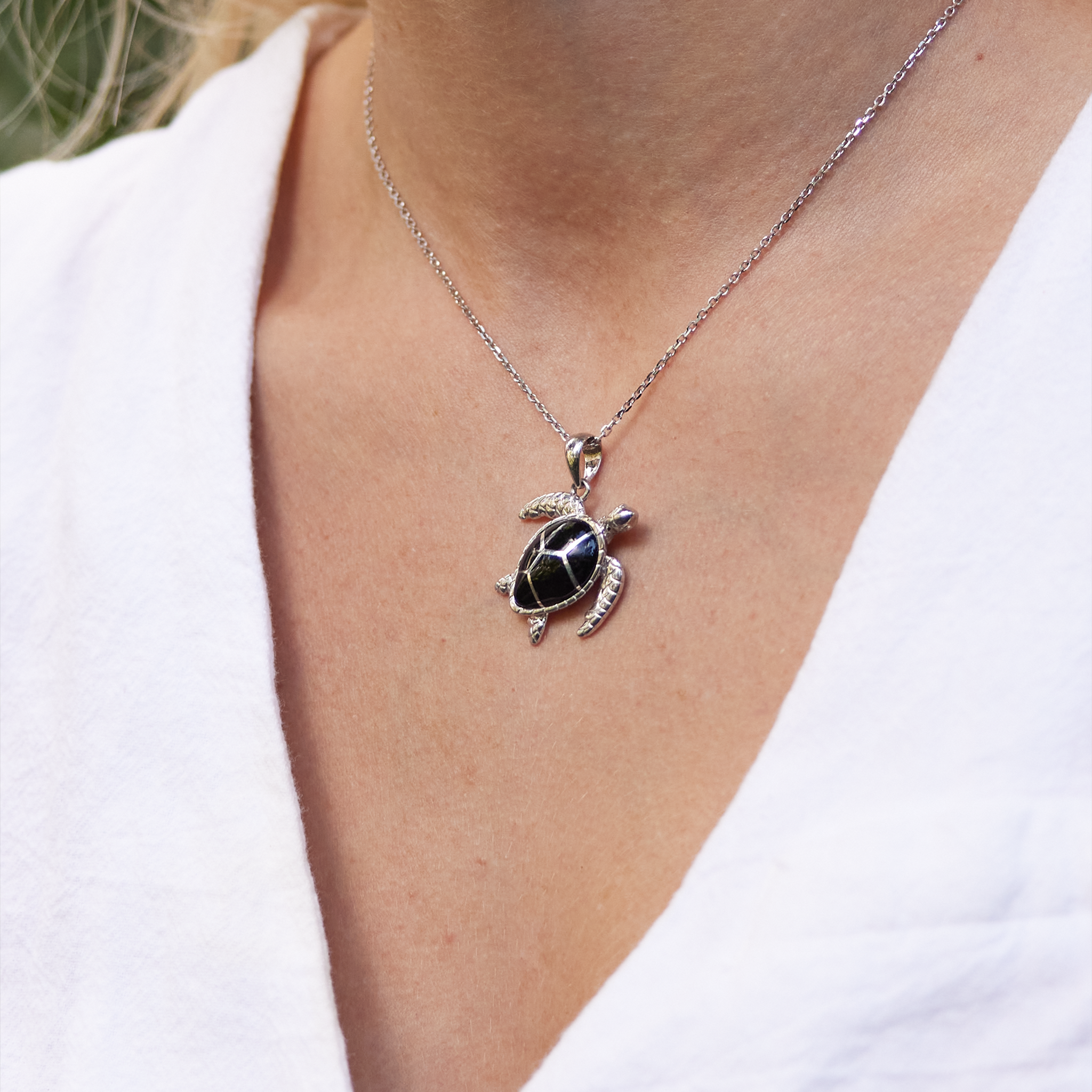Honu Black Coral Pendant in Sterling Silver on Womanʻs neckline