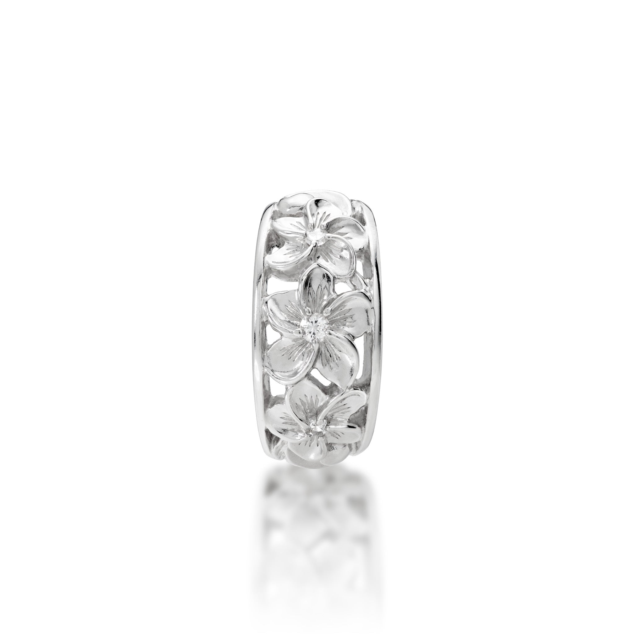 Top view of the 11mm Hawaiian Heirloom Plumeria White Sapphire Ring in Sterling Silver on a white background