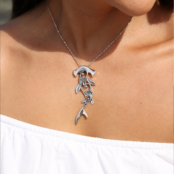 A womanʻs chest with a Living Heirloom Hammerhead Shark Pendant in Sterling Silver - 70mm - Maui Divers Jewelry