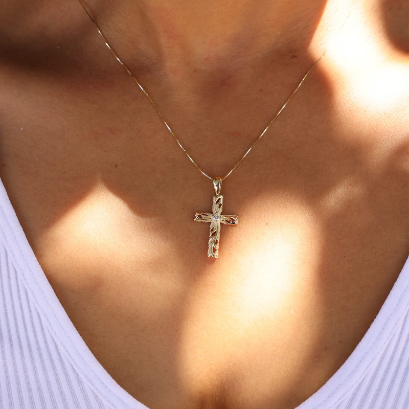 Hawaiian Heirloom Old English Scroll Cross Pendant in Gold with Diamond  on Chest just below the necklace with a white shirt