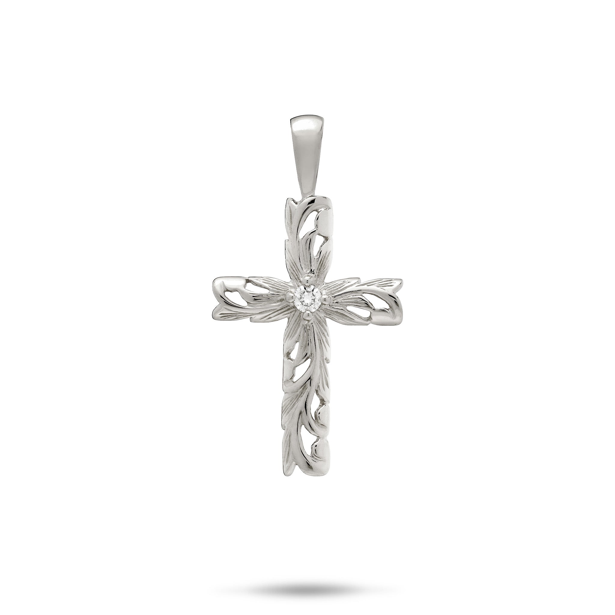 A 14k white gold cross pendant featuring Hawaiian heirloom scrollwork with maile leaves, ferns, and a diamond accent at the center, shown on a white background