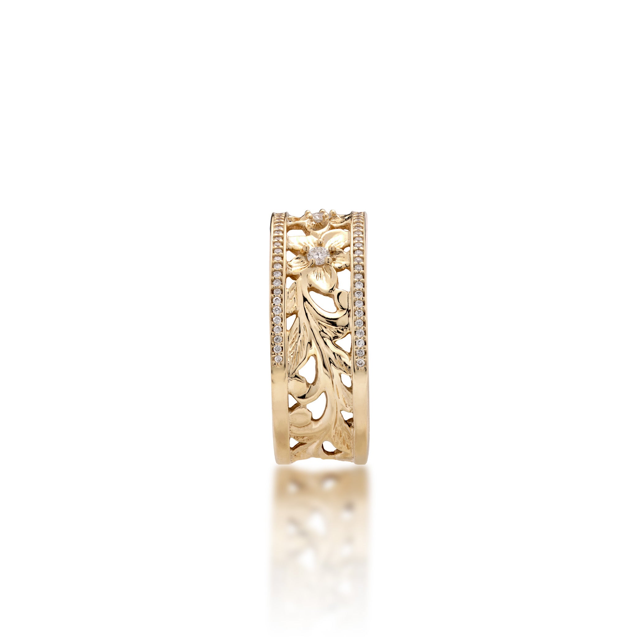A side view of a 14k yellow gold Hawaiian Heirloom Ring ring diamond-accented plumeria flowers at the top and fern and maile leaf scrollwork at the bottom and a row of pave set diamonds on each side of the band, shown on a white background