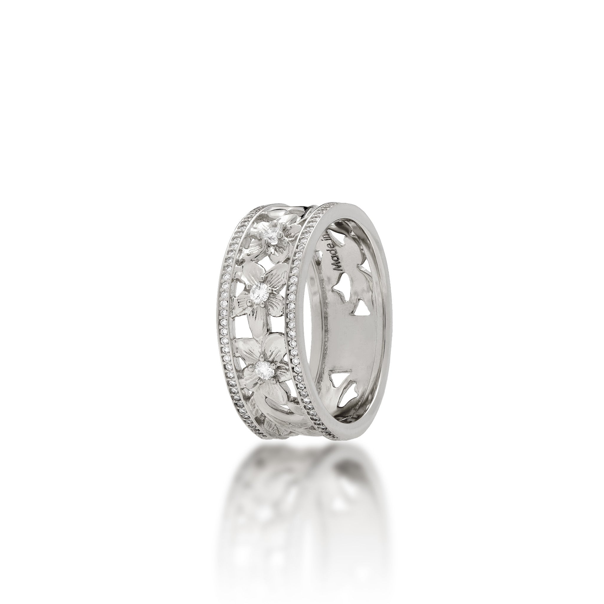 A 14k white gold Hawaiian Heirloom ring featuring a row of small pavé-set diamonds on each side of the band and cut-out diamond-accented plumeria flowers at the center, shown on a clean white background with a soft reflection below.