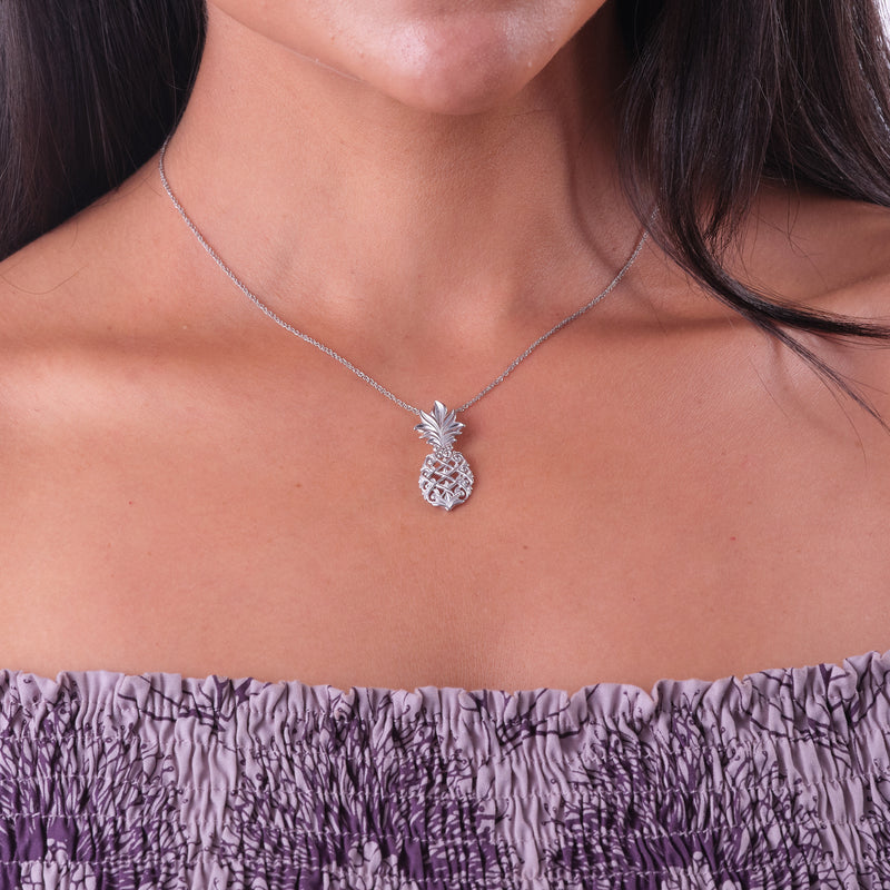 A woman's chest with a Living Heirloom Pineapple Pendant in White Gold - 30mm - Maui Divers Jewelry
