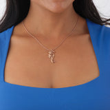 A woman's chest with a Living Heirloom Seahorse Pendant in Rose Gold with Diamonds - Maui Divers Jewelry