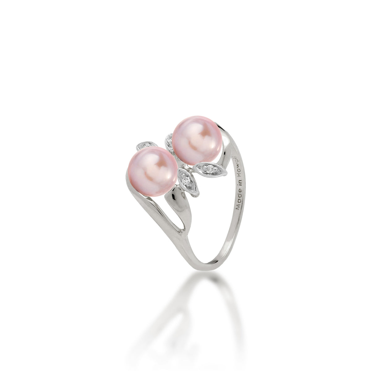 A 14k white gold ring with two lavender freshwater pearls and two diamond accent maile leaves on each side, shown on white background