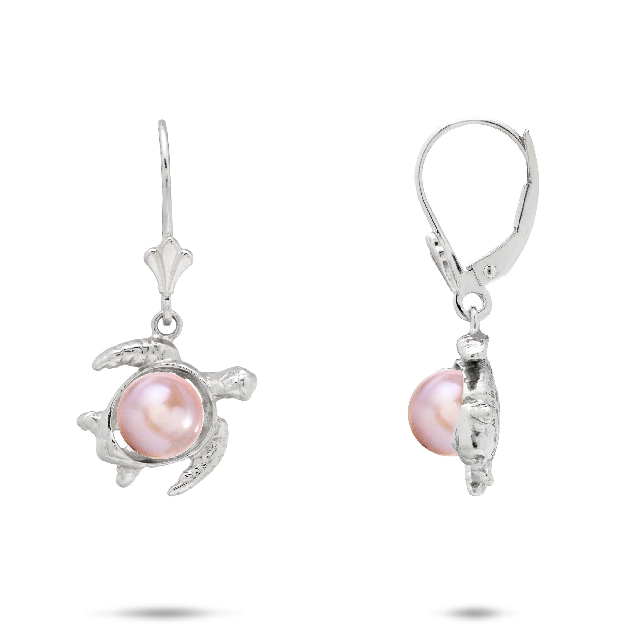 A pair of sterling silver earrings featuring a Hawaiian green sea turtle-shaped setting holding a round, pink freshwater pearl, shown against a plain white background.