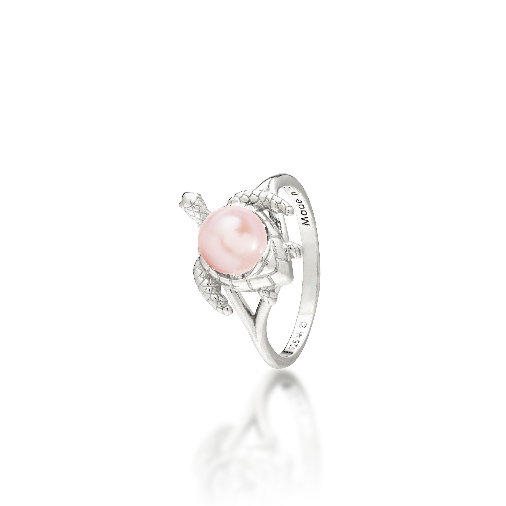 A sterling silver ring featuring a central pink freshwater pearl set on a Hawaiian green sea turtle's back, on a white background with a soft reflection.