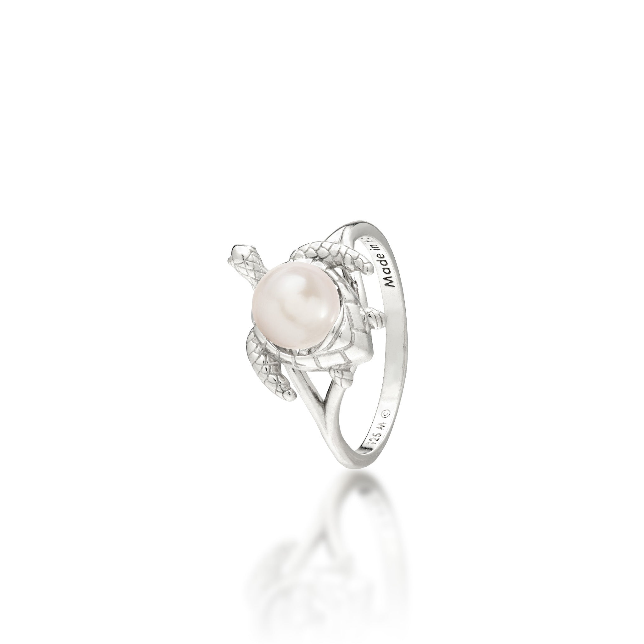 A sterling silver ring featuring a central white freshwater pearl set on a Hawaiian green sea turtle's back, on a white background with a soft reflection.