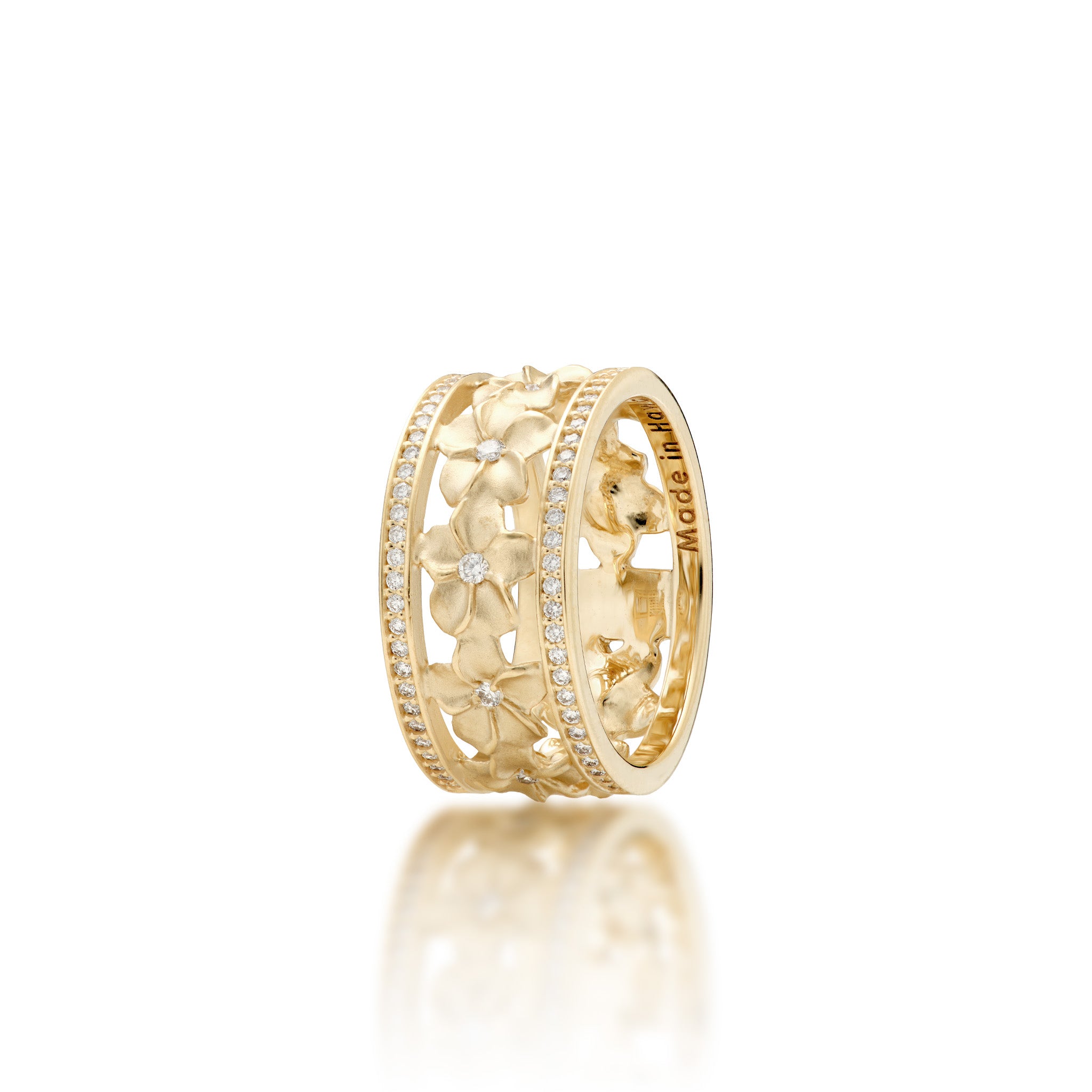 Angle view of the 10mm Plumeria Ring in Gold with Diamonds on a white background