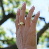 A woman's hand wearing a Hawaiian Gardens Hibiscus Ring in Tri Color Gold with Diamonds - 8mm - Maui Divers Jewelry