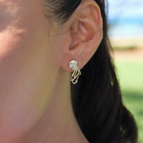 A woman's ear with Ocean Dance Jellyfish Earrings in Gold with Diamonds - 20mm - Maui Divers Jewelry