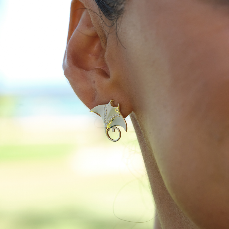 A womanʻs ear with Ocean Dance Manta Ray Earrings in Gold with Diamonds - 19mm - Maui Divers Jewelry