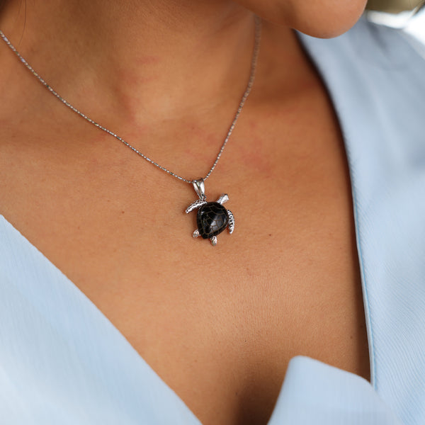 Close up of woman wearing Honu Black Coral Pendant in White Gold