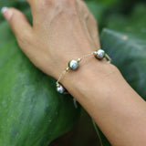 Tahitian Black Pearl Bracelet in Gold - 9-10mm - Size 7.5-8" on wriest with leafy background