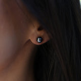 close up of Tahitian Black Pearl Earrings in White Gold - 8-9mm on ear