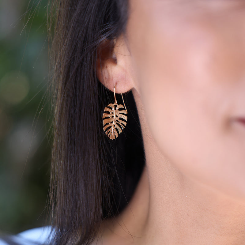 close up of woman wearing Monstera Earrings in Rose Gold - 23mm
